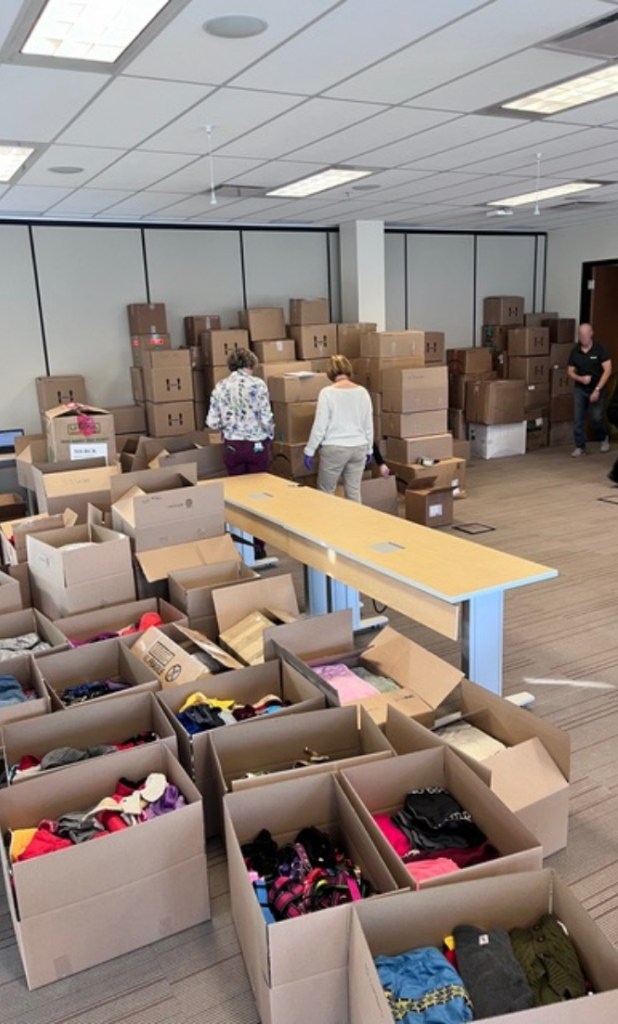 Image of the collecting center full of donations being organized.