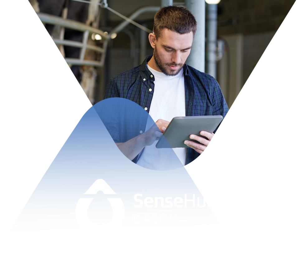 A man holding a tablet with the logo SenseHub Dairy